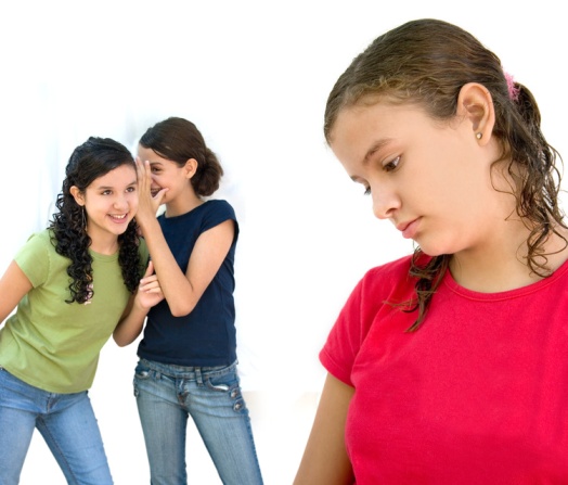 Two girls tell secrets behind a third girl's back